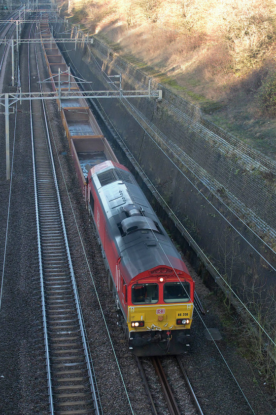 66206, 11.23 Bescot-Wembley (6Z02), Roade Cutting 
 No doubt in preparation for some of the many engineering works taking place over the festive period, 66206 leads a short set of empty IEA-A ballast wagons through Roade Cutting as the 6Z02 11.23 Bescot to Wembley. 
 Keywords: 66206 11.23 Bescot-Wembley 6Z02 Roade Cutting