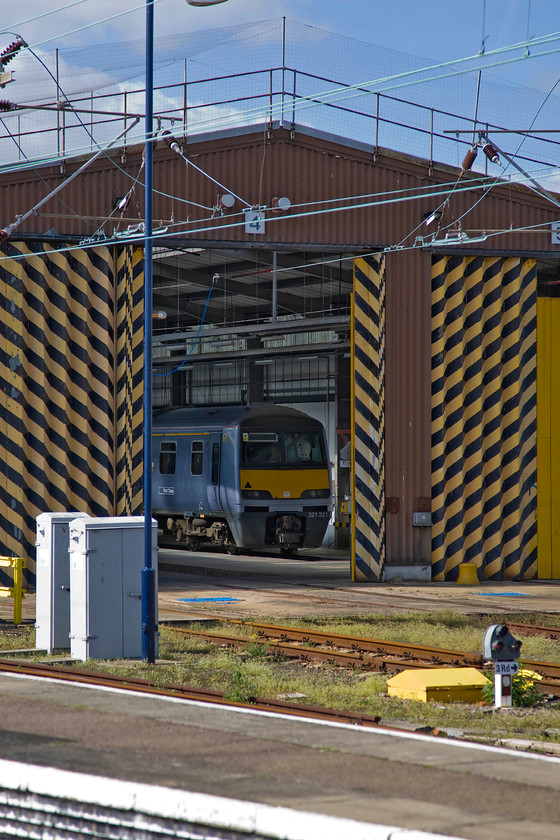 321321, stabled, Clacton-on-Sea CSD 
 Greater Anglia's 321321 undergoes attention inside Clacton's small depot. Built by BREL at York between 1988 and 1991 these one hundred miles per hour units proved to be incredibly reliable and marked a step-change in the travelling experience for many commuters in the south-east. Their roles have evolved over the years with them being cascaded as new stock has been introduced but they are still going strong now being twenty-five years old. 
 Keywords: 321321 stabled Clacton-on-Sea CSD