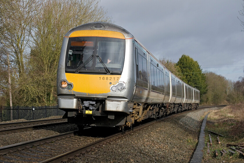 168217, CH 08.45 Birmingham Moore Street-London Marylebone (1H27, 2L), Claydon crossing SP451498 
 With an improving picture, in terms of the weather at least, the 08.45 Birmingham Moore Street to Marylebone Chiltern service passes Claydon worked by 168217. These dramatically silver-painted units are beginning to look a little work-stained now if the front of this one is anything to go by! 
 Keywords: 168217 08.45 Birmingham Moore Street-London Marylebone 1H27 Claydon crossing SP451498