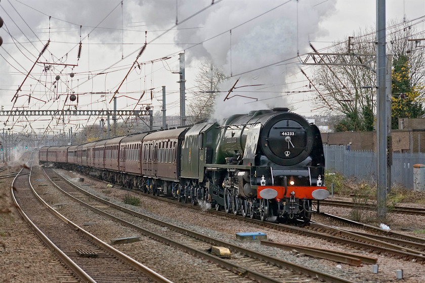 46233, outward leg of The Lindum Fayre, 09.08 London King's Cross-Lincoln (1Z46), Alexandra Palace station 
 Having left King's Cross some four miles south of this location on time 46233 'Duchess of Sutherland' has been leading The Lindum Fayre charter on the fast line. However, as can be seen in this photograph control have lost their nerve and are moving it to the slow line here at Alexandra Palace. However, the cross over is a flying junction and the charter is still going at a fair rate of knots as it passes.

There is an audio recording of this event on my youtube channel, see....https://youtu.be/6UPgNRBff3g 
 Keywords: 46233 The Lindum Fayre, 09.08 London King's Cross-Lincoln 1Z46 Alexandra Palace station Railway Touring Company RTC Duchess of Sutherland