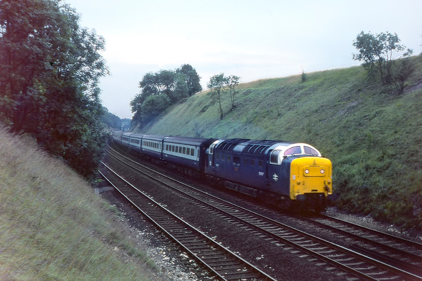 55007, 17.05 London King's Cross-Hull, 'The Hull Executive' (1D04), Little Ponton SK939330 
 By the early evening, the light had really dropped a situation made even worse as I am now located in a deep cutting at Great Ponton on the northern flank of Stoke bank just south of Grantham. 55007 'Pinza' descends Stoke leading one of the ECML's few named trains, the fabled Hull Executive. This crack express, that on launch in 1978, had to maintain an average speed of over ninety-one miles per hour between London and Retford. However, by the summer 1980 timetable, it was re-timed to leave King's Cross at 17.05 running now with three stops at Newark, Retford and Doncaster until it reached Humberside with stops at Goole and Brough. 
 Keywords: 55007 17.05 London King's Cross-Hull The Hull Executive 1D04 Little Ponton SK939330