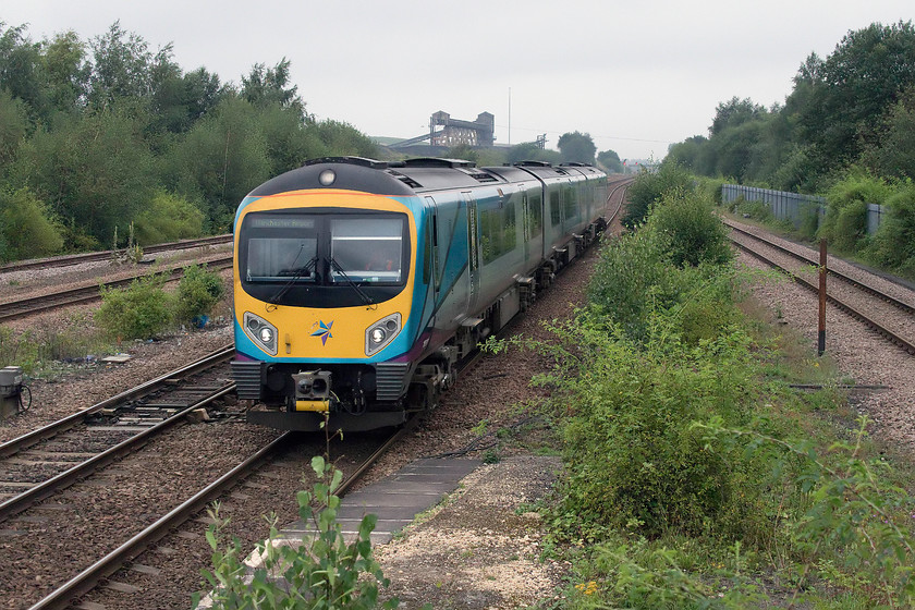 Class 185, TP 15.26 Cleethorpes-Manchester Airport (1B85, 8L), Hatfield & Stainforth station 
 With the winding gear of the closed Hatfield colliery behind it, an unidentified TPE class 185 passes Hatfield and Stainforth station forming the 1B85 15.26 Cleethorpes to Manchester Airport service. Notice in the foreground the uncontrolled vegetation growth between the running lines at the end of the platforms. By this time next year, these relatively small saplings will be brushing the sides of passing trains. I hope that the Network Rail arborists can get out and do their work before this happens. 
 Keywords: Class 185 15.26 Cleethorpes-Manchester Airport 1B85 Hatfield & Stainforth station