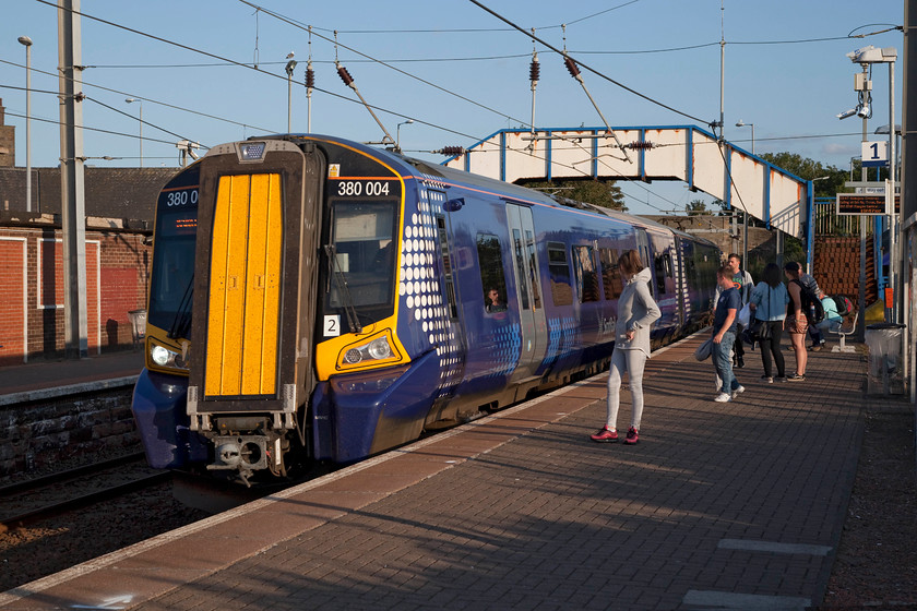 380004, SR 19.45 Ayr-Glasgow central (1K60, RT), Newton-on-Ayr station 
 With a lovely evening sun creating a superb soft warm light, 380004 arrives into Newton-on-Ayr working the 19.45 Ayr to Glasgow Central. The station sits on the hypotenuse of a triangle of railways that still exist but are unused. There are extensive sidings that are now totally overgrown. There is also a network of lines that go down to the harbour, also now disused. 
 Keywords: 380004 1K60 Newton-on-Ayr station