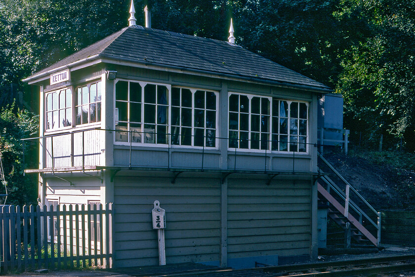 Ketton signal box (Mid, 1900) 
 Ketton signal box (or Ketton and Collyweston to give it its official name) has always been a tricky signal box to capture on film, see.. https://www.ontheupfast.com/p/21936chg/26500876404/ketton-signal-boxand even back in 1981 this was the case! The Midland box was built in 1900 and, at the time of writing in 2023, is still in use controlling the level crossing and what must be one of the most enduring survivals, a Midland Railway wooden-posted lower quadrant signal. Notice the MR three-quarter milepost in front of the box. 
 Keywords: Ketton signal box