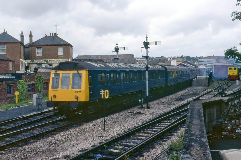 P473, Class 118 DMU, ECS, Paignton South 
 Having worked into Paignton's BR station a little earlier a pair of Class 118 DMUs with set P473 leading makes its way out of the station towards the Goddrington carriage sidings. The lines off to the right lead to Paignton's South Devon Railway station with one of its shunters just in shot. Notice the two hundred and twenty-two milepost to the left. This is the distance from Paddington via Swindon, Bath and Bristol rather than the Berks and Hants route. 
 Keywords: P473 Class 118 DMU ECS Paignton South Empty Coaching Stock