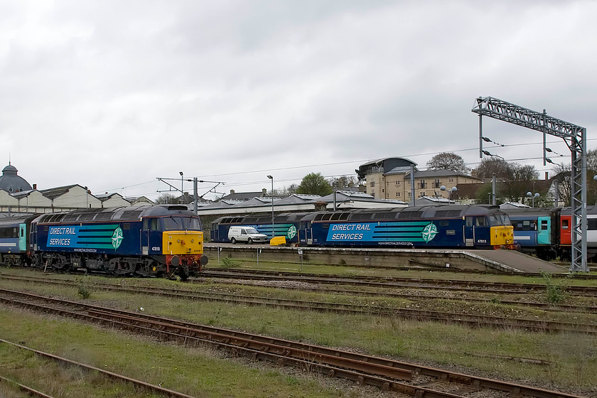 47818, 47841 & 47813 stabled, Norwich yard 
 Stabled in the yard adjacent to Norwich station are three of DRS' finest in the form of 47818, 47841 and 47813 'Solent'. All are stabled ready to undertake work hired to Greater Anglia who are still having problems with unit availability. Notice the period Austin Maestro Van on the platform complete with a small British Rail wording and the famous double arrow. Most of us will remember these in yellow all over the network during the later 1980s replacing the hundreds of Bedford HA vans that they had on their books. 
 Keywords: 47818, 47841 & 47813 stabled, Norwich yard DRS Direct Rail Services Solent