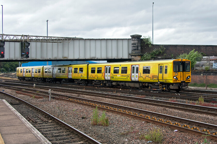 507010, ME 14.45 Chester-Chester (2C35, 1L), Chetser station 
 Up for imminent replacement.

Passing under Hoole bridge 507010 arrives at Chester with the 2C35 14.45 circular service via Liverpool Central. Dating from the late 1970s the 507s are the oldest trains still in regular use on the network (except for some of the Scottish and GWR HST carriages and power cars) and are up for imminent replacement by the Class 777s that are currently being delivered and undergoing testing; behind schedule of course! 
 Keywords: 507010 14.45 Chester-Chester 2C35 Chetser station Merseyrail