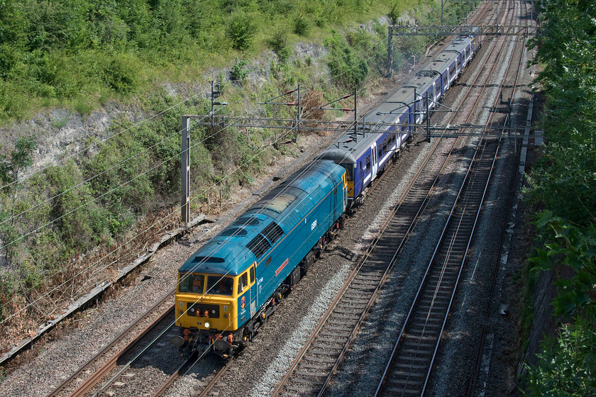 47749, 360107 & 47739, 12.15 Ilford EMUD-Northampton EMD (5Q36, 14L), Roade cutting 
 In a welcome burst of sunshine 47749 'City of Truro' leads the 5Q36 Ilford to Northampton unit drag move through Roade cutting. Former Greater Anglia 360107 is being taken from its former Essex base to Northampton for temporary storage and modification work at the Siemens' depot prior to its use on the MML working Corby to St. Pancras trains. At the rear of the train is 47739. 
 Keywords: 47749 360107 47739 12.15 Ilford EMUD-Northampton EMD 5Q36 Roade cutting GA Desiro GNRf City of Truro