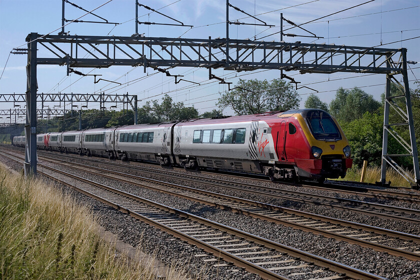 221118 & 221103, VT 09.10 London Euston-Holyhead (1D83), Bradwell SP831391 
 A pair of Voyagers in the form of 221118 and 221103 get away from Milton Keynes working the 1D83 09.10 Euston to Holyhead train. There are precious few locations in Milton Keynes to get reasonable access to take photographs of trains. They nearly all rely on the use of a ladder to elevate oneself above the height of palisade fencing. This particular spot is in Bradwell very close to Milton Keynes' Youth Hostel. 
 Keywords: 221118 221103 09.10 London Euston-Holyhead 1D83 Bradwell SP831391 Virgin Trains Voyager Mungo Park