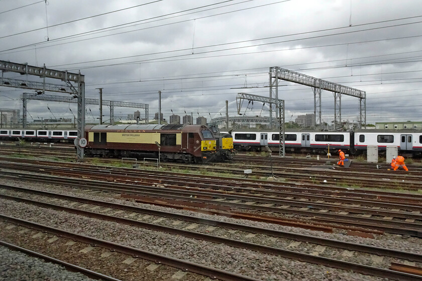 67024 & 37884, stabled, Wembley Yard 
 With a backdrop of Wembley Stadium and lines of warm-stored former Greater Anglia Class 321s 67024 and 37884 'Cepheus' are seen stabled in the yard from our passing train. The sight of Class 67s is getting increasingly rare now as they are proving to be less popular with operators with just twenty-one of the original thirty still operating with many of those seeing very little use. 
 Keywords: 67024 37884, stabled, Wembley Yard