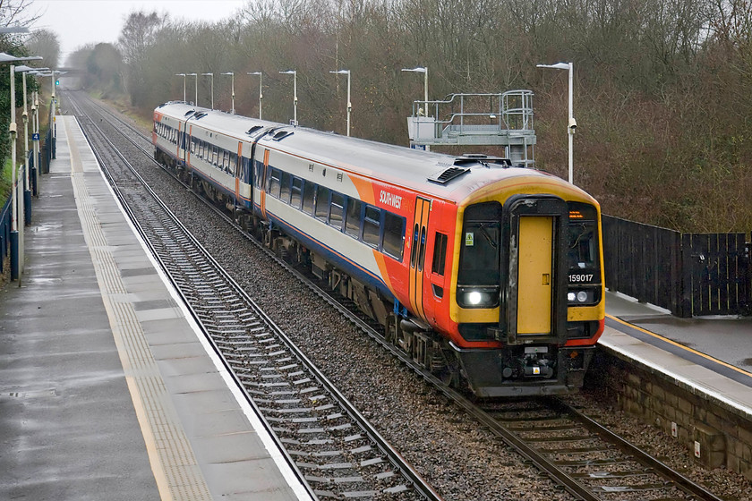 159017, SW 12.47 Salisbury-London Waterloo (1L42), Whitchurch station 
 159017 passes through Whitchurch station working the 12.47 Salisbury to Waterloo. At least the bright livery carried by South West Trains lightens the tone of the almost monochrome grey December day! 
 Keywords: 159017 SW 12.47 Salisbury-London Waterloo 1L42 Whitchurch station South West Trains