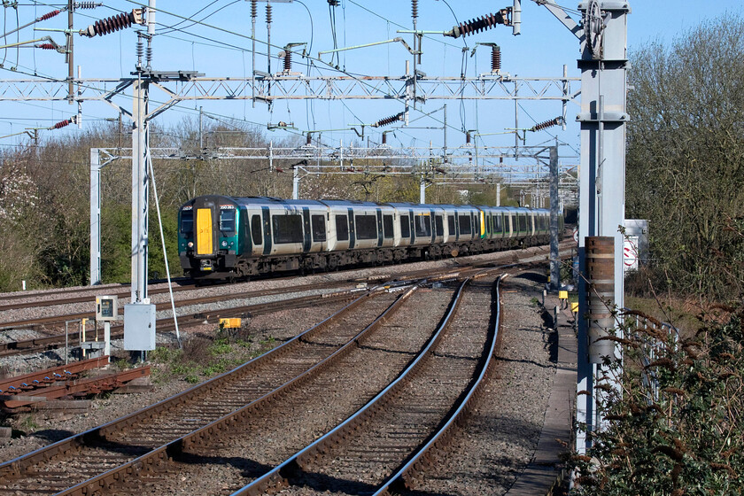 350263, LN 08.56 Milton Keynes-London Euston (2K10, 2L), Spenlows bridge 
 A spot that I have observed many times from passing trains but one that I have never visited is between Bletchley and Milton Keynes. Locally named Spenlows bridge (with no apostrophe) is a small footbridge that spans the line including the recently realigned and signalled pair of tracks nearest the camera to and from the partially rebuilt viaduct carrying the east-west link that is currently under construction. 350263 and another Desiro approach the bridge working the 2K10 Milton Keynes to Euston all stations stopper service. 
 Keywords: 350263 08.56 Milton Keynes-London Euston 2K10 Spenlows bridge London Northwestern Desiro