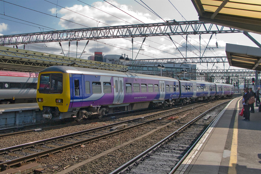 323233, NT 10.14 Manchester Piccadilly-Manchester Airport (2A75), Manchester Piccadilly station 
 After a very dull start, the sun has begun to emerge and it was turning into a very pleasant summer's day. At Manchester Piccadilly one of Northern's class 323 units leaves with the 10.14 to Manchester Airport. 323233 is one of a number that Northern Trains operate in the north-west and like their cosins in the West Midlands, they are dependable and relaible units tahta are the backbone of local services. 
 Keywords: 323233 10.14 Manchester Piccadilly-Manchester Airport 2A75 Manchester Piccadilly station Northern Trains