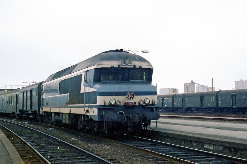 72072, unidentified working, Nantes station 
 72072 arrives at Nantes station with an unidentified working from the east. As was the case on UK railways of the time, note the parcels wagon coupled directly behind the locomotive. Close observation reveals that this particular loco. is named. Try as I have, I can find no record of the names applied to a number of the class C'C' locomotives. 
 Keywords: 72072 Nantes station