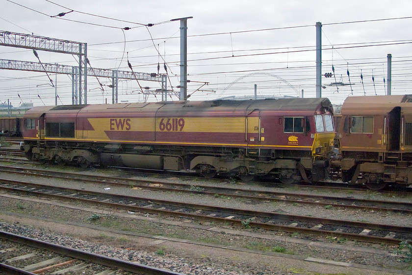 66119 & 66138, stabled, Wembley yard 
 Having not moved a wheel since we passed heading in the other direction yesterday, 66119 and 66138 are seen stabled in Wembley yard. It is clear that 66138 has not been through the washer since undertaking RHT work in the last few months! Notice that both locomotives have their cab doors open. Is this really a good idea I have to ask myself allowing any inclement winter weather to do its worst? 
 Keywords: 66119 66138 stabled Wembley yard