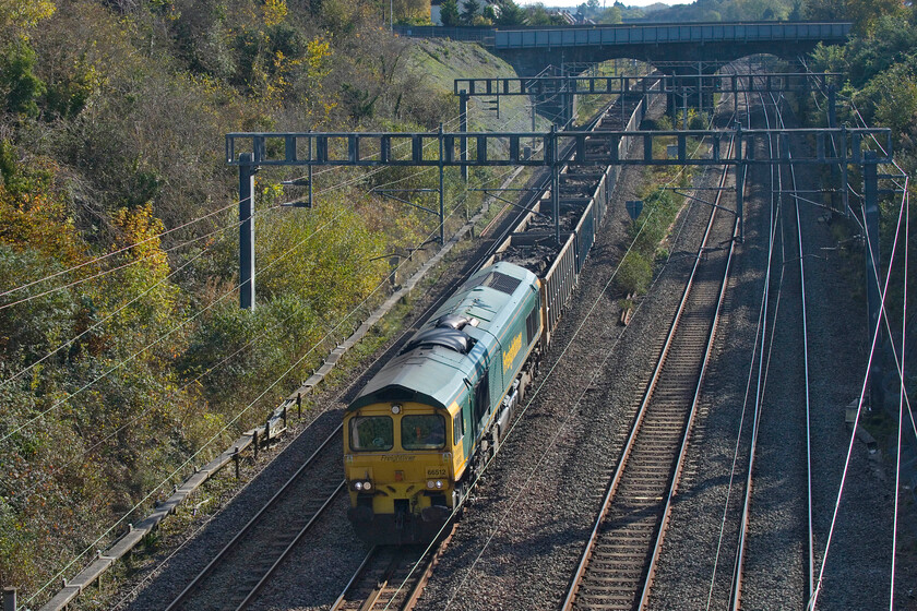 66512, 09.36 Willesden Euroterminal-New Bilton (6R93, 95L), Hyde Road bridge 
 Yet another load of spoil from HS2 works to the north-west of London makes its way to a new home in an abandoned quarry near Rugby. Led by 66512 the 6R93 09.36 Willesden Eusroterminal to new Bilton passes Roade seen from the village's Hyde Road bridge. This train now runs twice a day with the balancing empty wagon working coming back this way in a few hours. Unfortunately, today, this working was running extremely late, it should have passed this spot nearly two hours earlier. 
 Keywords: 66512 09.36 Willesden Euroterminal-New Bilton 6R93 Hyde Road bridge Freightliner