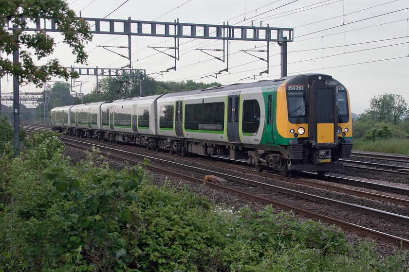 350261, LN 05.29 Bletchley-Liverpool Lime Street (9F32, 2L), Ashton Road bridge 
 I must be mad! I got up at 05.00 to walk across the field from home and photograph a class 350! Well, that's not quite the whole story, I was there for another reason but 350261 passed working the unusual 9F32 05.29 Bletchley to Liverpool Lime Street. I presume that this is more of a positioning working but it is an oddity none-the-less. 
 Keywords: 35026 05.29 Bletchley-Liverpool Lime Street 9F32 Ashton Road bridge