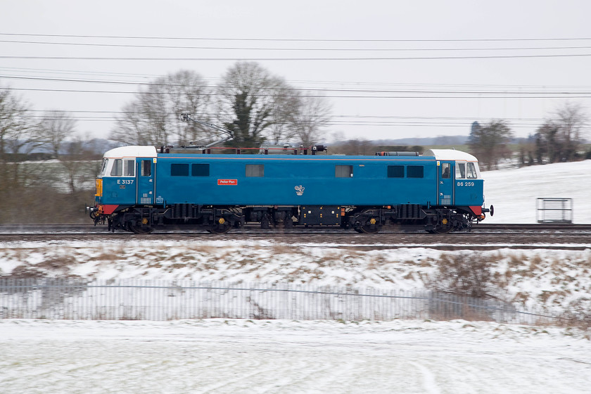 86259, 12.40 Acton CS-Rugby CS LE (0Z88), between Roade & Ashton 
 86259 'Peter Pan' (on this side at least!) heads north through the snowy countryside in Northamptonshire between Roade and Ashton. It was working the 12.40 Acton to Rugby Carriage Sidings 0Z88 light engine movement. This follows the veteran 86's railtour duties the previous day. In between such railtours the 86 could be seen sitting rather forlornly in the overgrown carriage sidings at Rugby. 
 Keywords: 86259 12.40 Acton CS-Rugby CS LE 0Z88 between Roade & Ashton