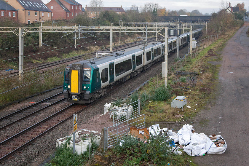 350240, 350267 & 350257, LN 09.05 Northampton-London Euston (1N20, 4L), site of Roade station 
 This day was the first of a series of Saturdays on the run-up to Christmas with industrial action being taken against London NorthWestern. There was a handful of trains running and this was one of them, a strengthened three-set service as the 09.05 Northampton to Euston. It is formed by three Desiros, 350240, 350267 and 350257, all of which, as 3502XXs, could well be going off-lease soon. Notice the detritus in the foreground left behind by Network Rail, If they want to stop vandalism, in particular, graffiti, they should do a lot more about keeping their own house in order first! 
 Keywords: 350240 350267 350257 09.05 Northampton-London Euston 1N20 site of Roade station DesiroLiondon NorthWestern strike industrial action