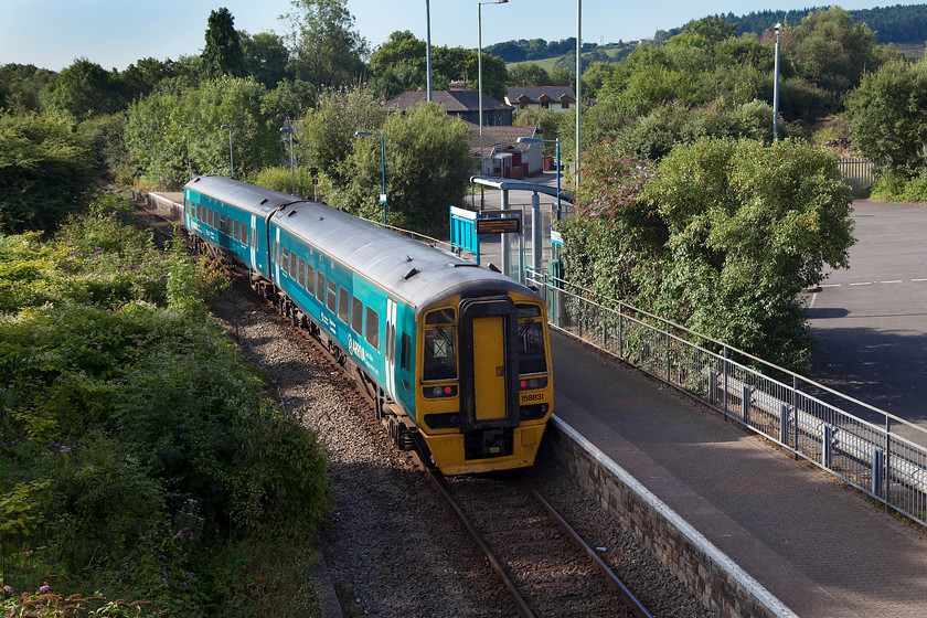 158831, AW 09.16 Maesteg-Cheltenham (2G56), Tondu station 
 158831 leaves all that remains of the once much larger station at Tondu. This small platform was one side of a V shaped platform arrangement with the major platform being off to the right of this image at the edge of the car park on the line that headed off to Margam. This line, whilst still extant, is extremely overgrown and out of use. 
 Keywords: 158831 09.16 Maesteg-Cheltenham 2G56 Tondu station