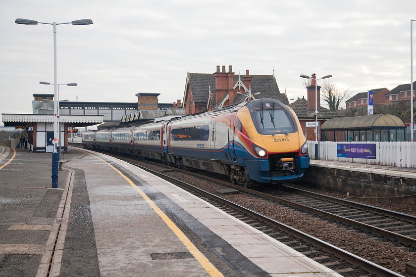 222013, EM 12.31 London St.-Pancras-Sheffield (1F32, 1L), Wellingborough station 
 222013 passes through Wellingborough station at line speed working the 12.31 St. Pancras to Sheffield. Wellingborough station was opened in 1847 by The Midland Railway. It is a grade II listed structure despite a number of alterations and changes that have taken place over the years. With the masts in place both north and south of the station, this view is set to change imminently as the march of electrification continues. 
 Keywords: 222013 12.31 London St.-Pancras-Sheffield 1F32 Wellingborough station