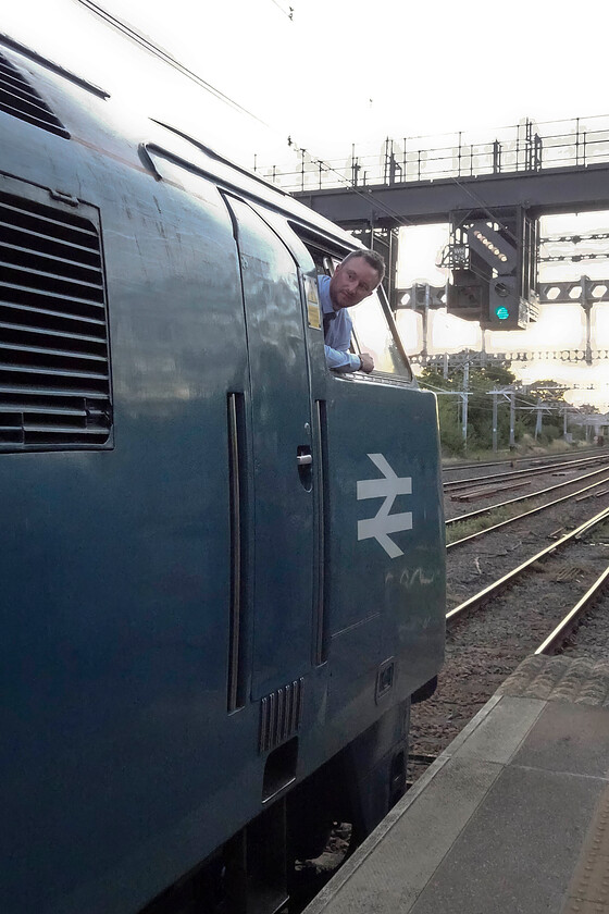 D1015, return leg of the Westbury Wizzo, 15.15 Cranmore-East Midlands Parkway (1Z79, 12L), Bedford station 
 Having arrived back at Bedford it was time for Andy and me to leave the Westbury Wizzo charter and let it continue its journey north to East Midlands Parkway. The driver peers back down the platform waiting for the RA but is 'wrong side' so will have to cross back to his seat and put down the power without a further confirmational look. Notice the feather on the gantry above the tracks indicating that D1015 'Western Champion' will be crossing over to the fast line for its journey. All in all, Andy and I had a great day out on the charter with the Western performing faultlessly. 
 Keywords: D1015 Westbury Wizzo 15.15 Cranmore-East Midlands Parkway 1Z79 Bedford station Western Champion