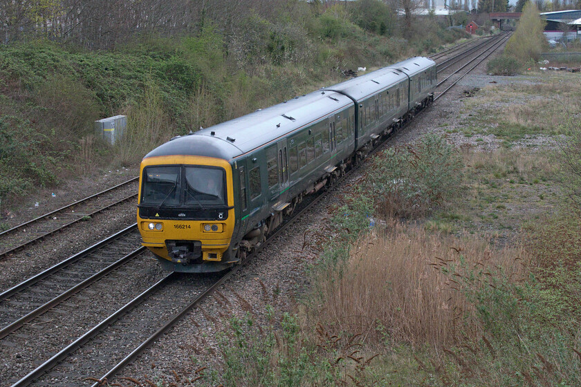 166214, GW 08.45 Great Malvern-Westbury (2C12, RT), Arle bridge 
 A regularly photographed GWR Turbo unit, by me at least, approaches Cheltenham taken from Arle Road bridge. 166214 is working the 08.45 Great Malvern to Westbury 2C12 service. Tewkesbury Road bridge, one of the main roads out of Cheltenham to the west, is seen in the distance. 
 Keywords: 166214 08.45 Great Malvern-Westbury 2C12 Arle bridge GWR Great Western Railway