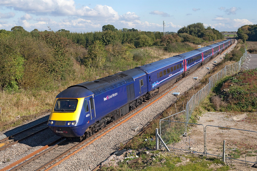 43171, GW 12.00 London Paddington-Bristol Temple Meads (1C13), site of Shrivenham station 
 43171 leads the 12.00 Paddington to Bristol Temple Meads past the site of Shrivenham station that is just behind the bridge on which I am standing. This bridge is a new replacement that has only recently opened and intended to give more height in order to accommodate the electrification wires that will be installed sometime in the future! The fenced off area to the right has just been vacated by the contractors who constructed the bridge. 
 Keywords: 43171 12.00 London Paddington-Bristol Temple Meads 1C13 site of Shrivenham station