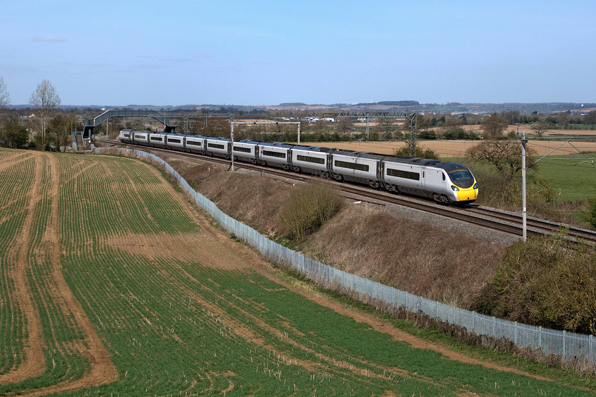 390148, VT 11.45 Wolverhampton-London Euston (1B51, RT), Milton crossing 
 390148 'Flying Scouseman' passes through Northamptonshire on a glorious spring day forming the 11.45 Wolverhampton to London Euston. This location is on the Weedon loop line just north of Roade cutting near the village of Blisworth and is not one that I use very often as most of the 'interesting' and photogenic workings go via the Northampton line! 
 Keywords: 390148 11.45 Wolverhampton-London Euston 1B51 Milton crossing Avanti West Coast Pendolino Flying Scouseman