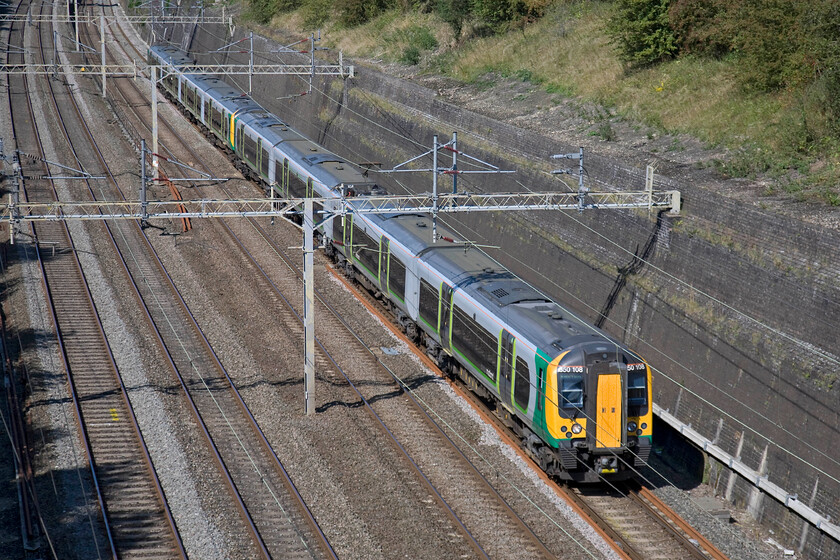 350108 & 350103, LM 11.37 Crewe-London Euston (1U30), Roade cutting 
 The 11.37 Crewe to Euston London Midland service is seen, as it is a Sunday, passing through Roade cutting on the up slow line rather than the fast as would be the case in the week. On this lovely early autumn day (or is it late summer?) 350108 and 350103 are working this train. 
 Keywords: 350108 350103 11.37 Crewe-London Euston 1U30 Roade cutting London MIdland Desiro