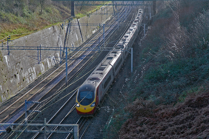 Class 390, VT 11.20 London Euston-Manchester Piccadilly (1H21), Roade cutting 
 With all but the roof in full and deep shadow an unidentified Class 390 heads north through Roade cutting working the 11.20 Euston to Manchetser Piccadilly. 
 Keywords: Class 390 VT 11.20 London Euston-Manchester Piccadilly 1H21 Roade cutting Virgin Trains Pendolino