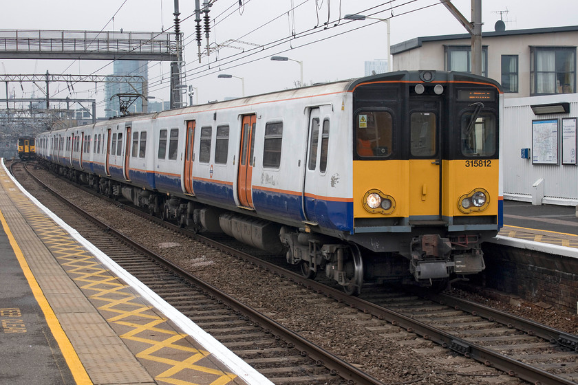 315812, LO 13.00 London Liverpool Street-Enfield Town (2U42, 1L), Bethnal Green station 
 London Overground operated 315812 comes to a halt at Bethnal Green station woking the 13.00 Liverpool Street to Enfield Town 2U42 service. Despite being overhauled in the last three of four years, this 39 year old unit will be withdrawn in the next couple of months or so as the class 710 Aventra units are introduced. 
 Keywords: 315812 13.00 London Liverpool Street-Enfield Town 2U42 Bethnal Green station