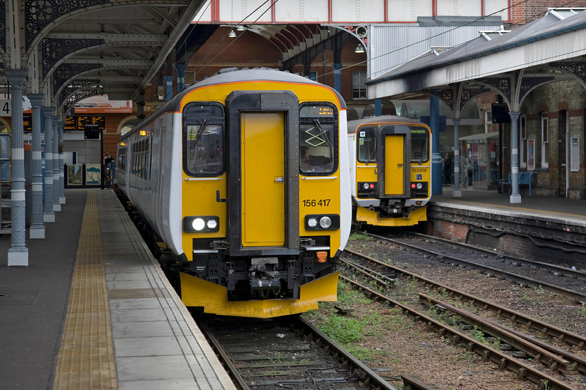 165417, LE 10.58 Norwich-Lowestoft (2J72) & 153309, LE 09.48 Lowestoft-Norwich (2J71), Norwich station 
 A pair of Greater Anglia units wait at Norwich station. To the left 165417 will work the 10.59 to Lowestoft imminently whilst to the right one of their single-car units, 153309, has terminated after working the 2J71 09.48 from Lowestoft. 
 Keywords: 165417 10.58 Norwich-Lowestoft 2J72 153309 09.48 Lowestoft-Norwich 2J71 Norwich station Greater Anglia GA